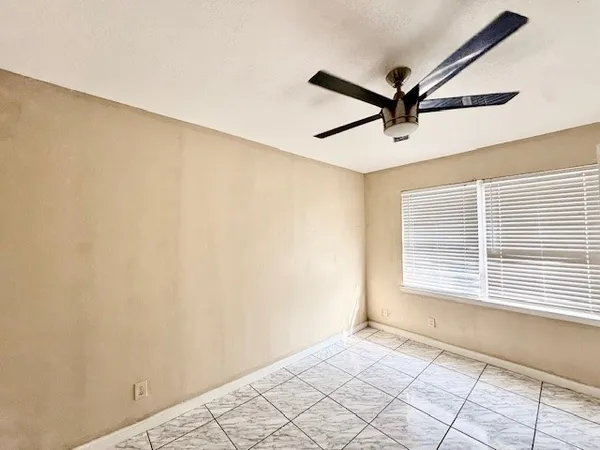 a view of a room with a window and a ceiling fan