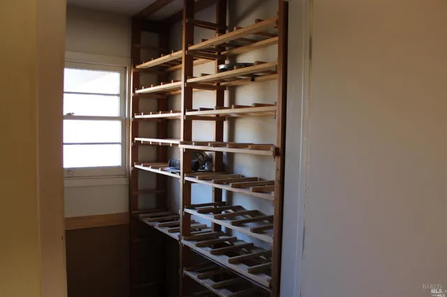 a bed sitting in a room next to a window