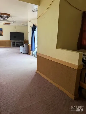 a view of storage and utility room with furniture and a window