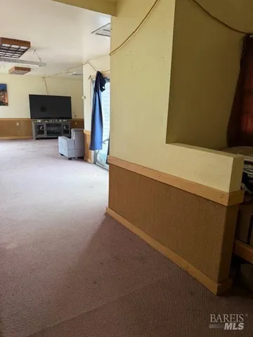 a view of storage and utility room with furniture and a window