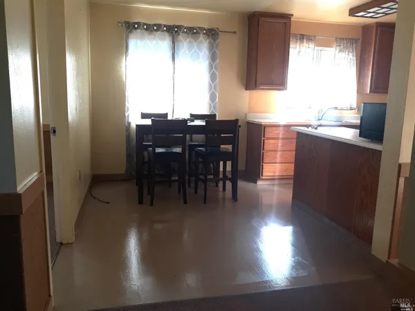 a view of a dining room with furniture and window
