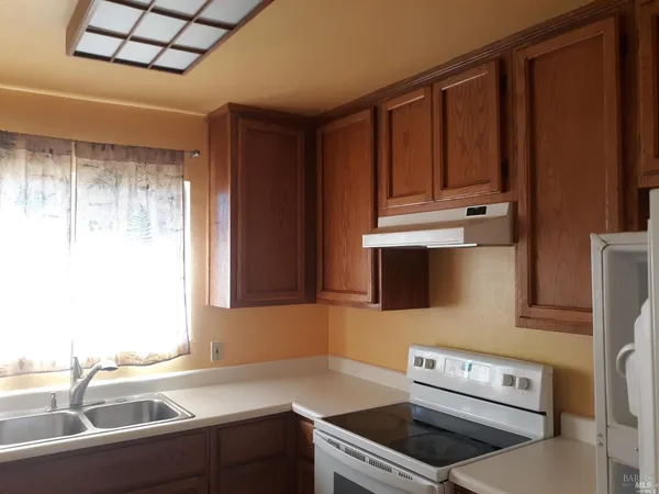 a kitchen with a sink appliances and cabinets