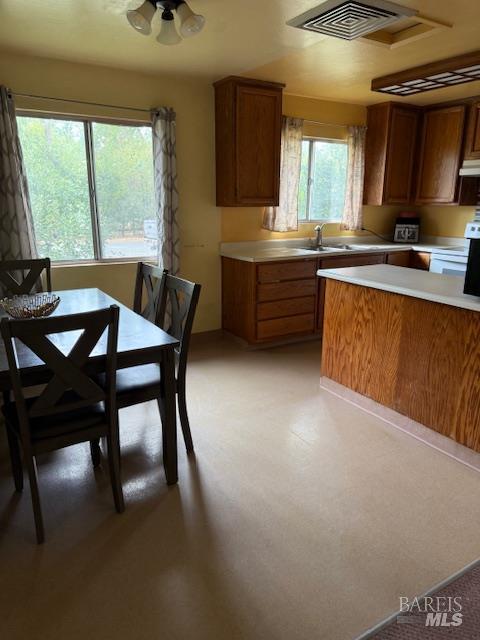 23740 Greely Street Covelo, CA 95428 - Photo 9 of 29 a kitchen with stainless steel appliances granite countertop a sink a stove a table and chairs
