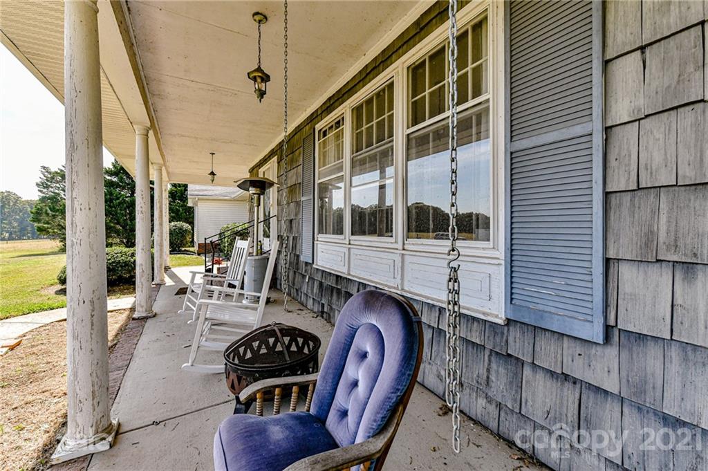 126 Baucom Deese Road Monroe, NC 28110 - Photo 4 of 28 a balcony with furniture and a potted plant