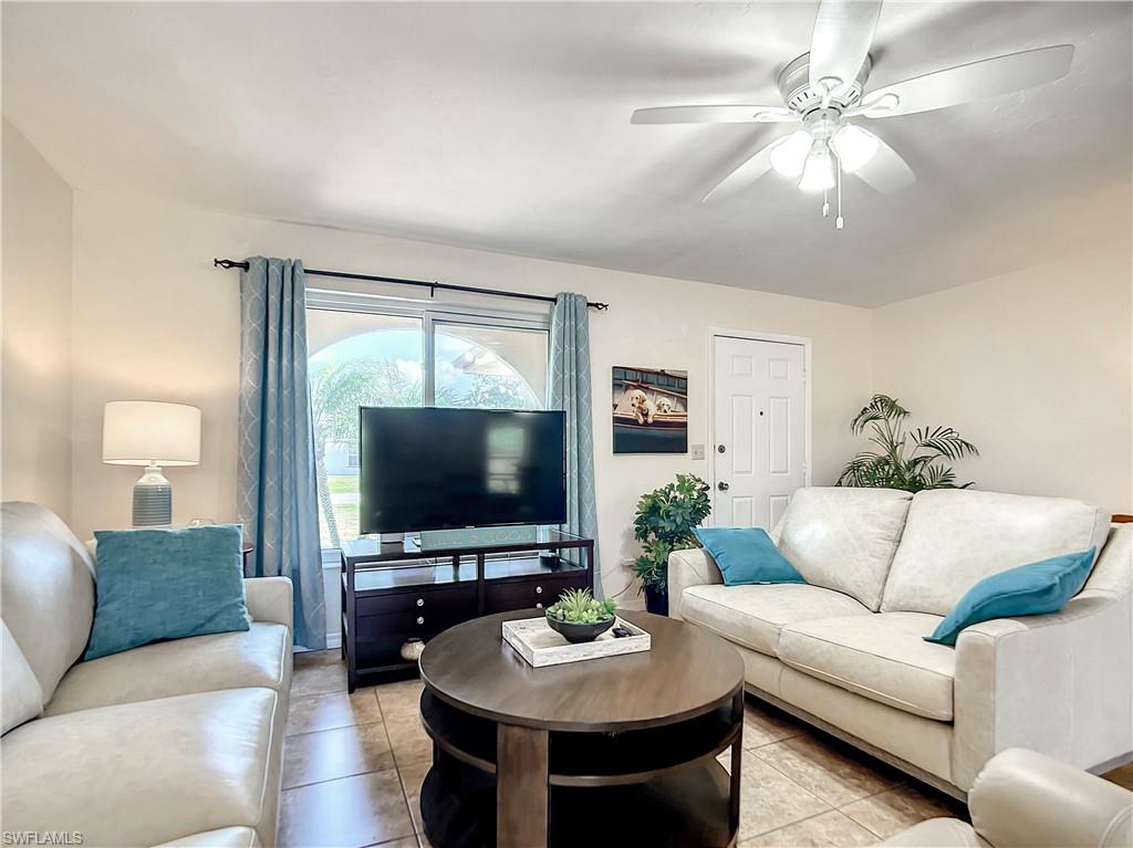 9072 Hamlin Road West Fort Myers, FL 33967 - Photo 1 of 50 a living room with furniture and a flat screen tv