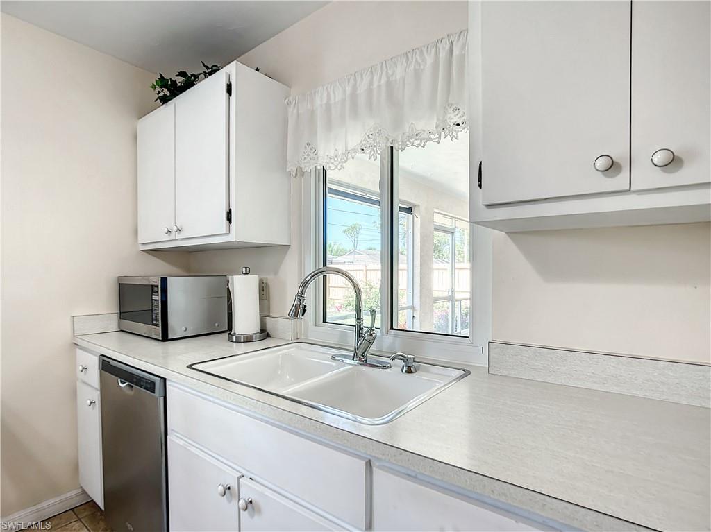 9072 Hamlin Road West Fort Myers, FL 33967 - Photo 15 of 50 a kitchen with stainless steel appliances granite countertop a sink and a white cabinets