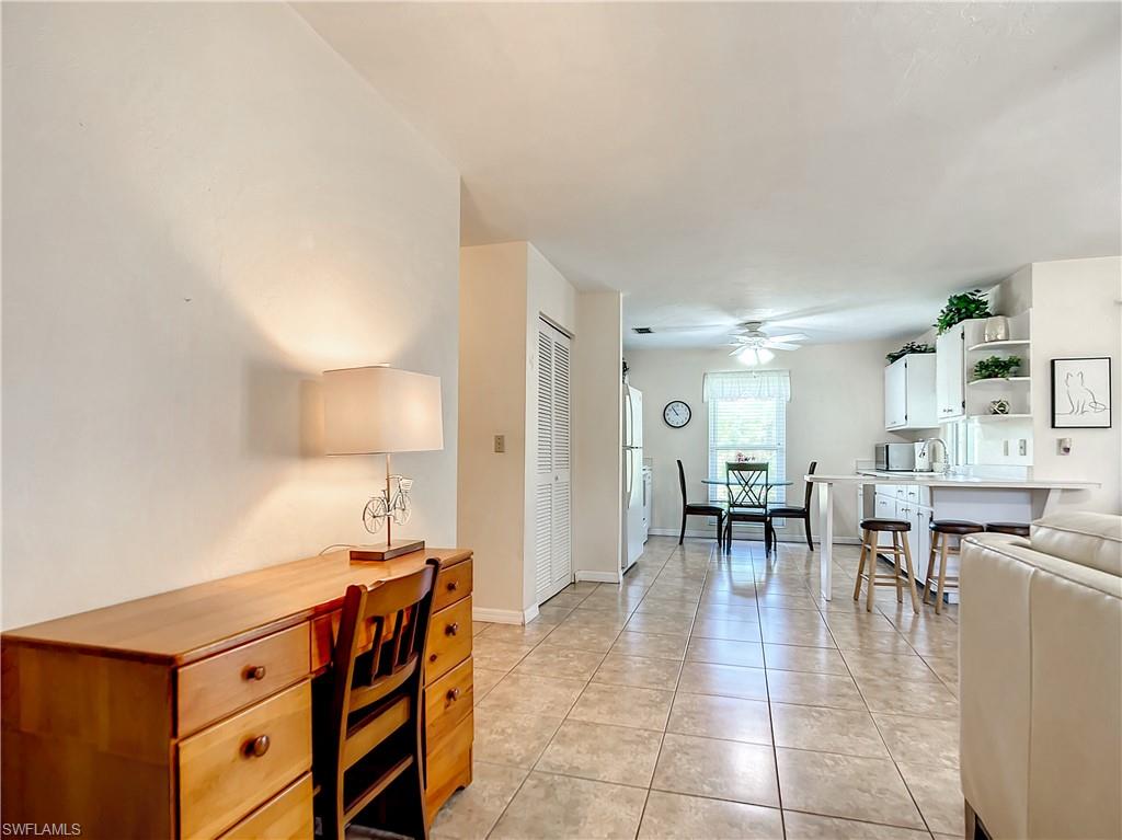 9072 Hamlin Road West Fort Myers, FL 33967 - Photo 16 of 50 a dining hall with stainless steel appliances a dining table and chairs with wooden floor