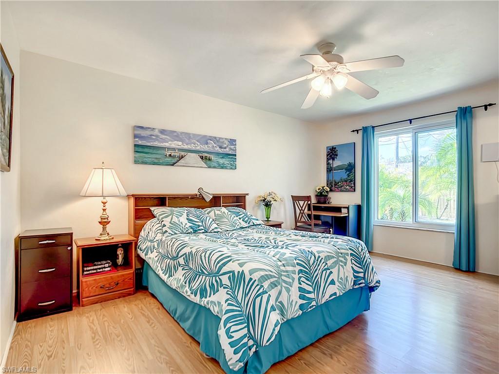 9072 Hamlin Road West Fort Myers, FL 33967 - Photo 17 of 50 a bedroom with a bed and a chandelier