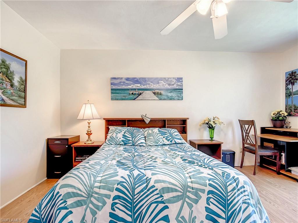9072 Hamlin Road West Fort Myers, FL 33967 - Photo 18 of 50 a bedroom with bed and a lamp