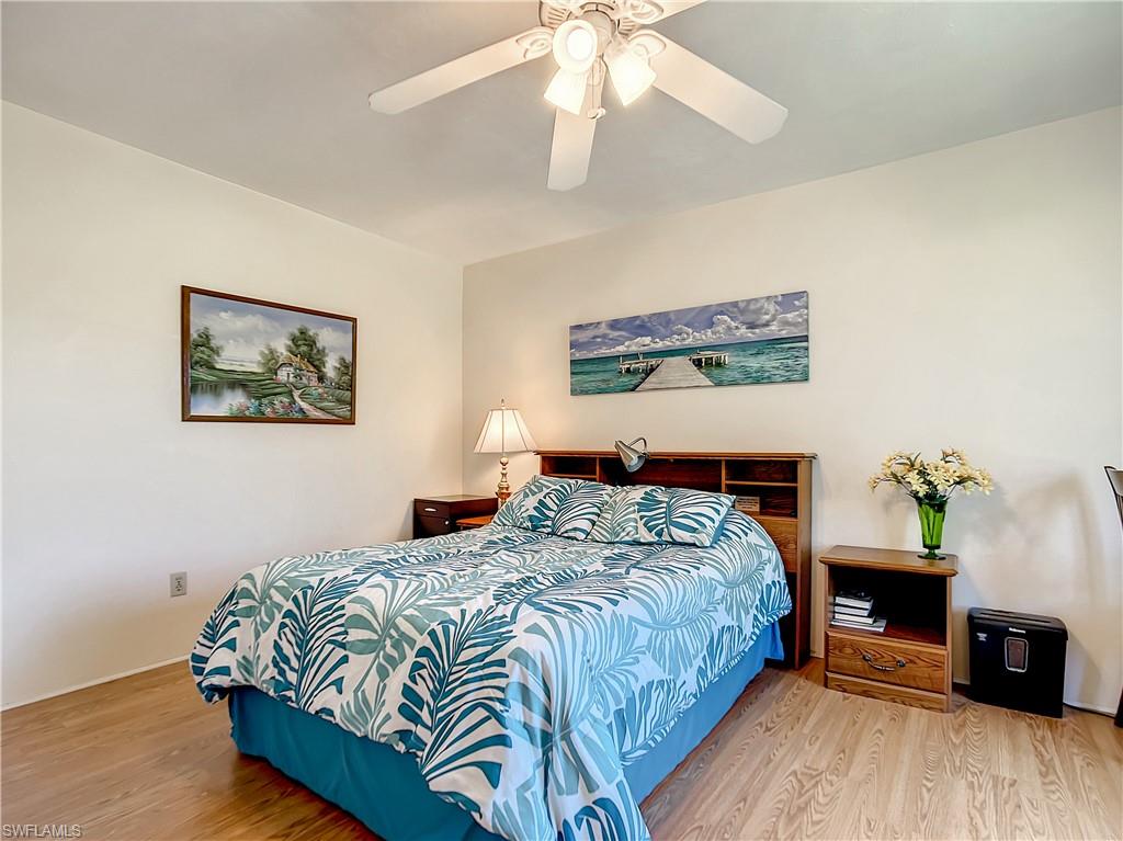 9072 Hamlin Road West Fort Myers, FL 33967 - Photo 19 of 50 a bedroom with bed and wooden floor