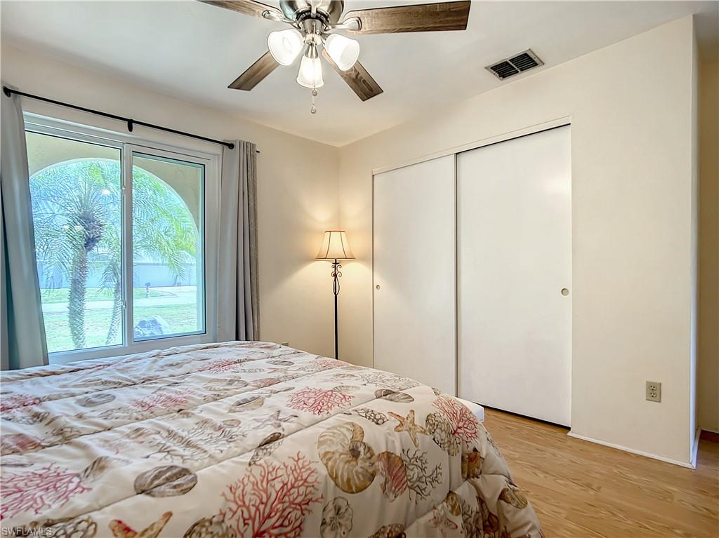9072 Hamlin Road West Fort Myers, FL 33967 - Photo 24 of 50 a bedroom with a large bed and a chandelier