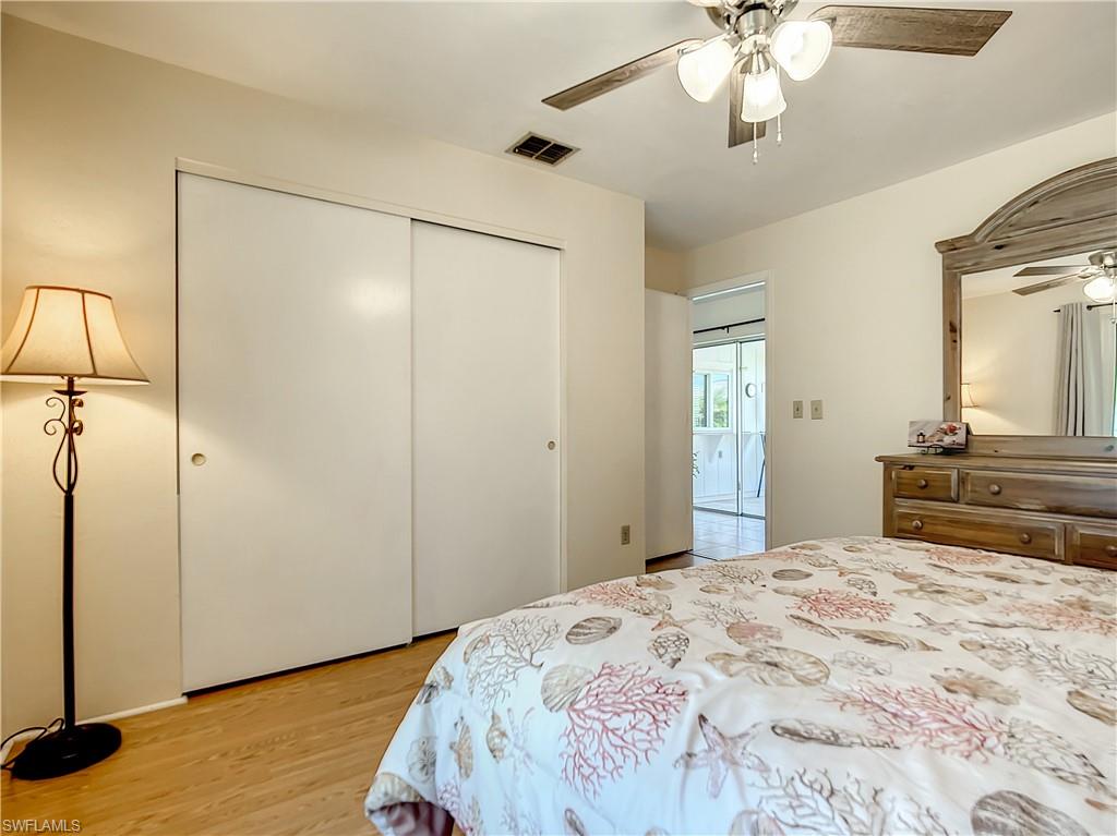 9072 Hamlin Road West Fort Myers, FL 33967 - Photo 27 of 50 a bedroom with a bed and a chandelier