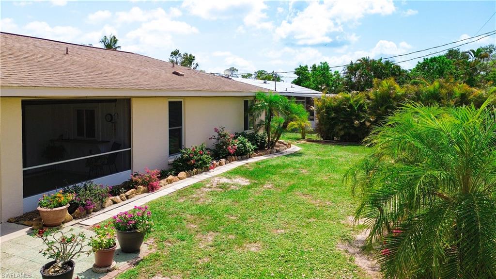 9072 Hamlin Road West Fort Myers, FL 33967 - Photo 29 of 50 a view of a house with a backyard and a garden