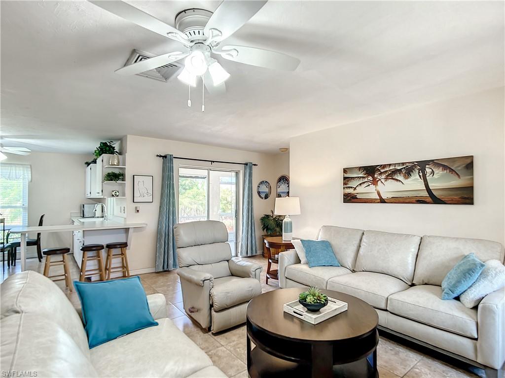 9072 Hamlin Road West Fort Myers, FL 33967 - Photo 3 of 50 a living room with furniture a table and a chandelier