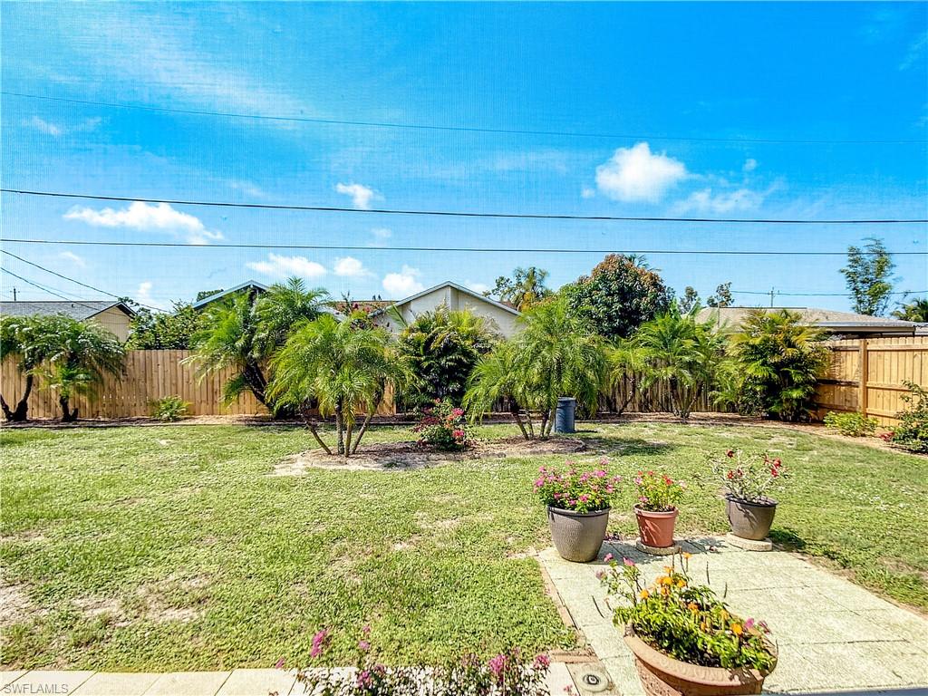 9072 Hamlin Road West Fort Myers, FL 33967 - Photo 36 of 50 a backyard of a house with lots of green space and fountain