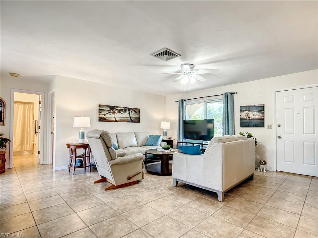 9072 Hamlin Road West Fort Myers, FL 33967 - Photo 6 of 50 a living room with furniture and a flat screen tv
