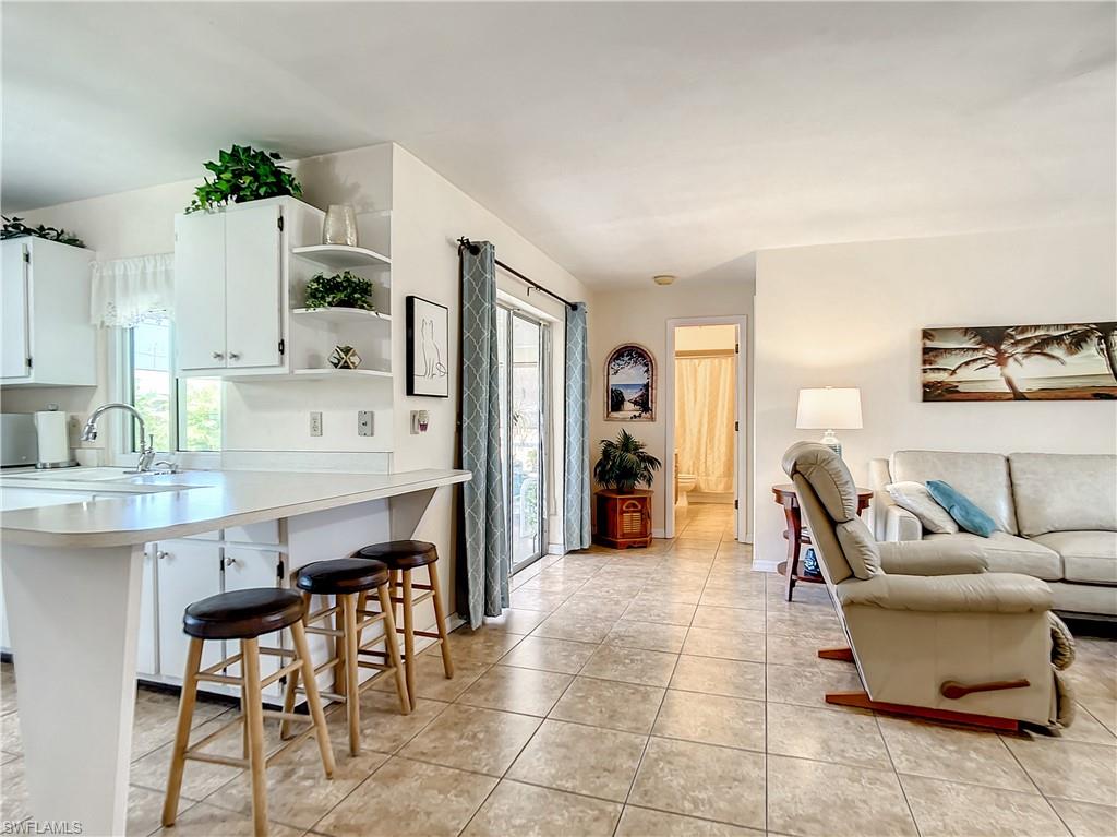 9072 Hamlin Road West Fort Myers, FL 33967 - Photo 10 of 50 a living room with furniture a dining table and chairs