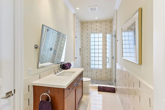 a bedroom with a bed and a flat tv screen on the dresser