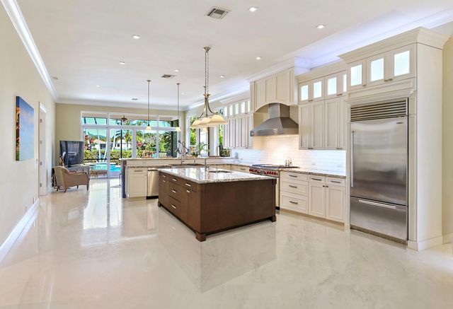 a large kitchen with a large counter top appliances and cabinets