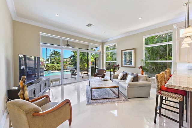 a living room with furniture a large window and a flat screen tv