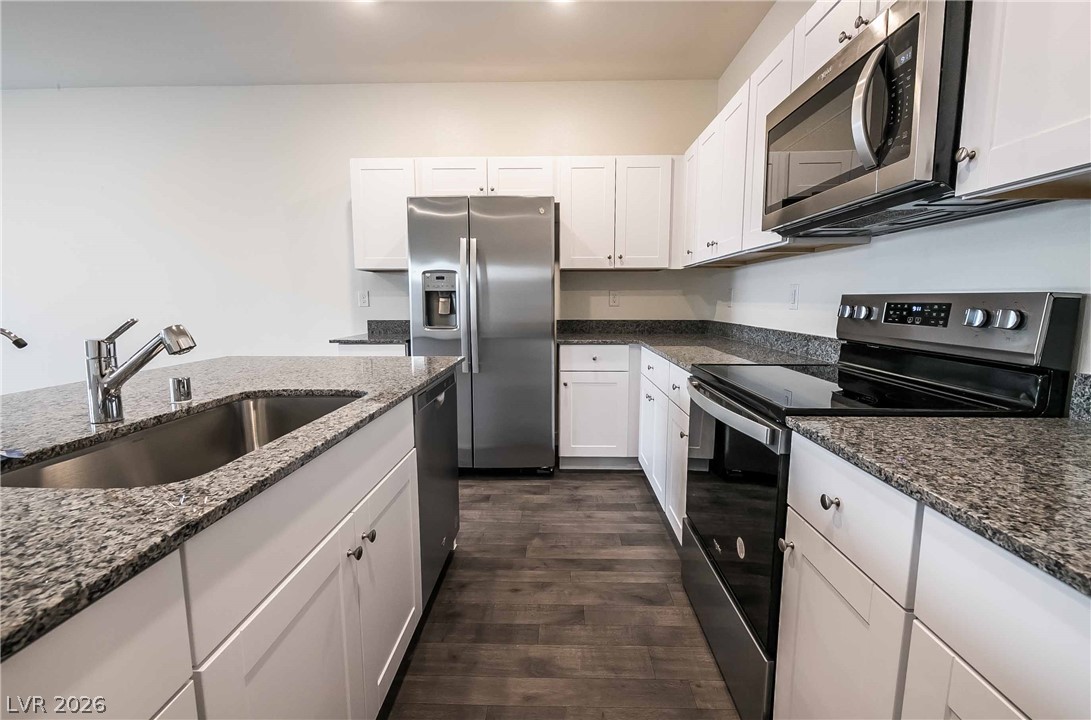 12749 Epperly Street Henderson, NV 89044 - Photo 6 of 22 Culinary creations come to life in this kitchen, boasting sleek stainless steel appliances and abundant counter space.