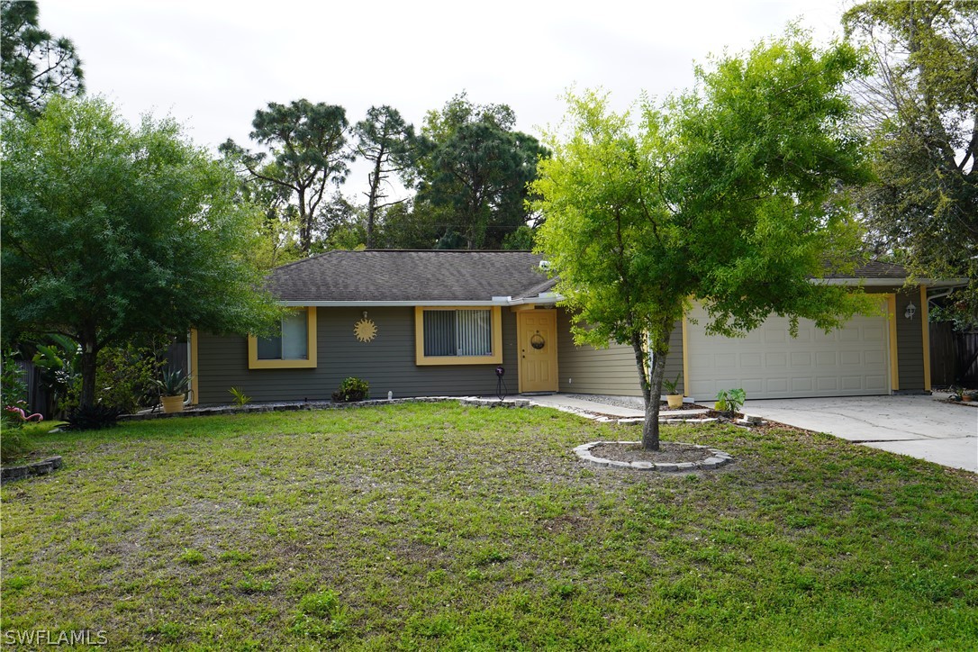 8036 Anhinga Road Fort Myers, FL 33967 - Photo 1 of 28 a front view of a house with a garden