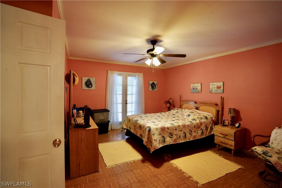 8036 Anhinga Road Fort Myers, FL 33967 - Photo 13 of 28 a bedroom with a bed and ceiling fan