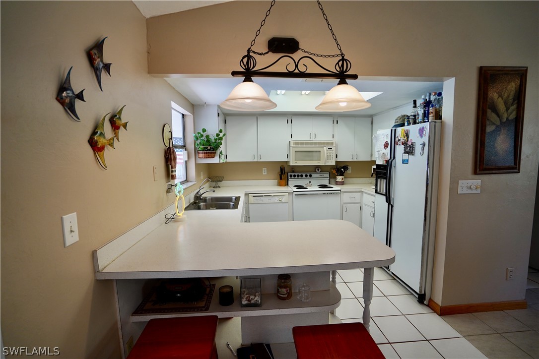 8036 Anhinga Road Fort Myers, FL 33967 - Photo 6 of 28 a kitchen with stainless steel appliances granite countertop a sink a stove and refrigerator