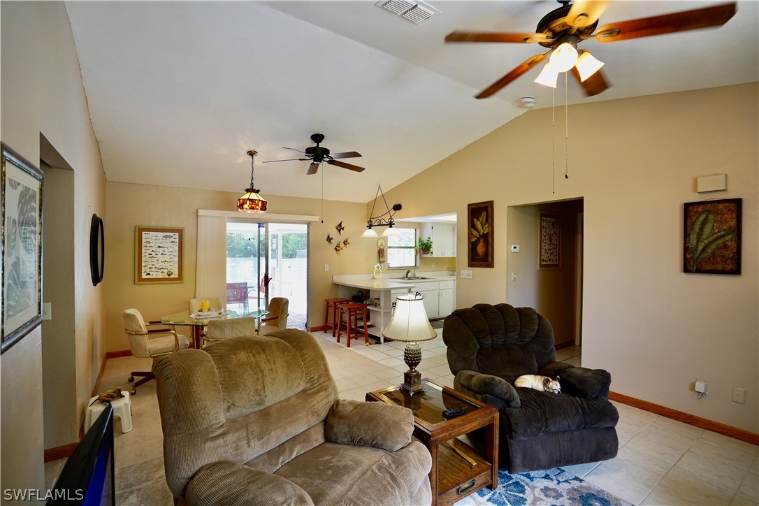 8036 Anhinga Road Fort Myers, FL 33967 - Photo 8 of 28 a living room with furniture a ceiling fan and a window
