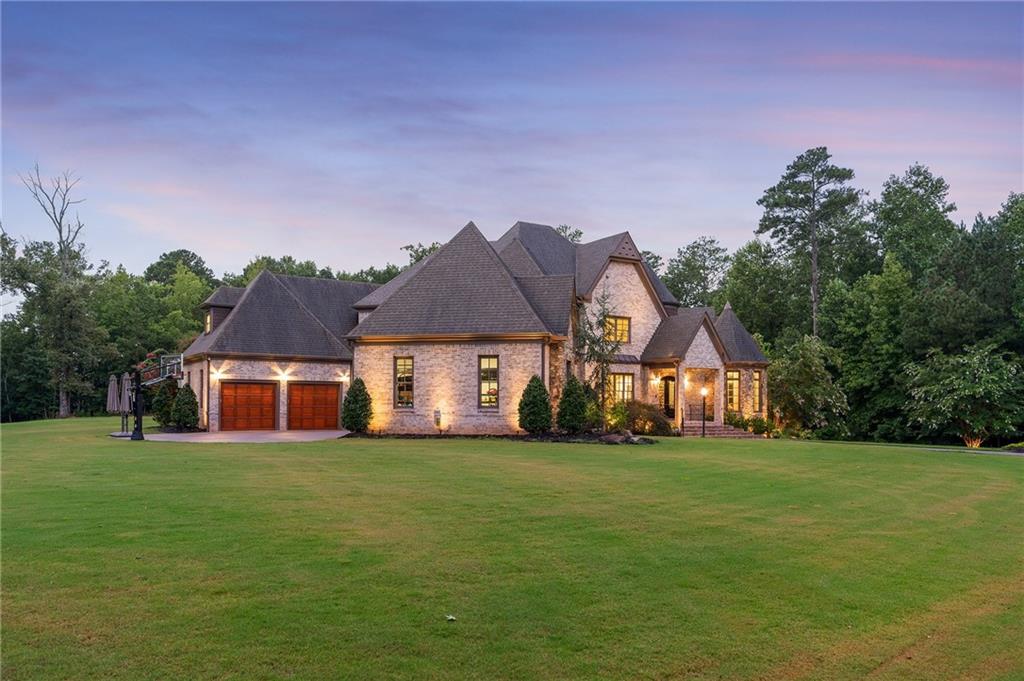 14560 Wood Road Milton, GA 30004 - Photo 69 of 74 a white house with a big yard and large trees