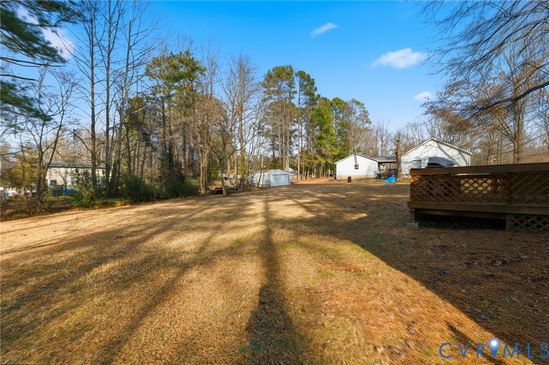 12145 White Bark Road Ruther Glen, VA 22546 - Photo 19 of 23 a view of a parking space with lots of trees in the background
