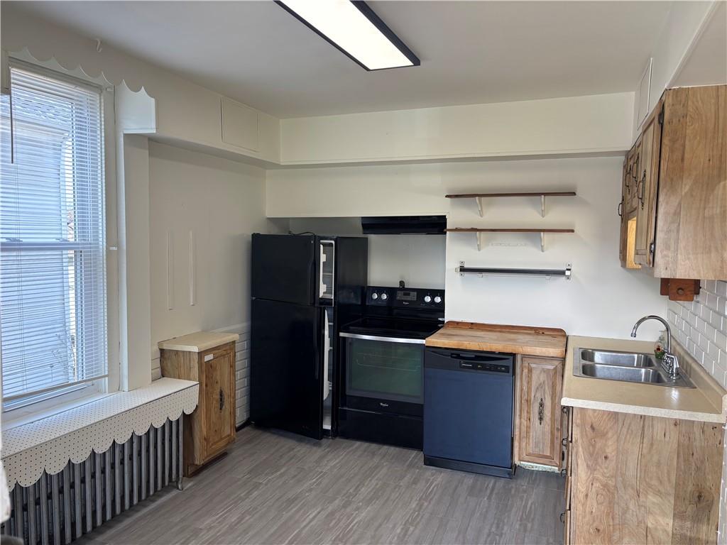 16 Oak Street Manor, PA 15665 - Photo 15 of 18 a kitchen with stainless steel appliances a sink and a refrigerator