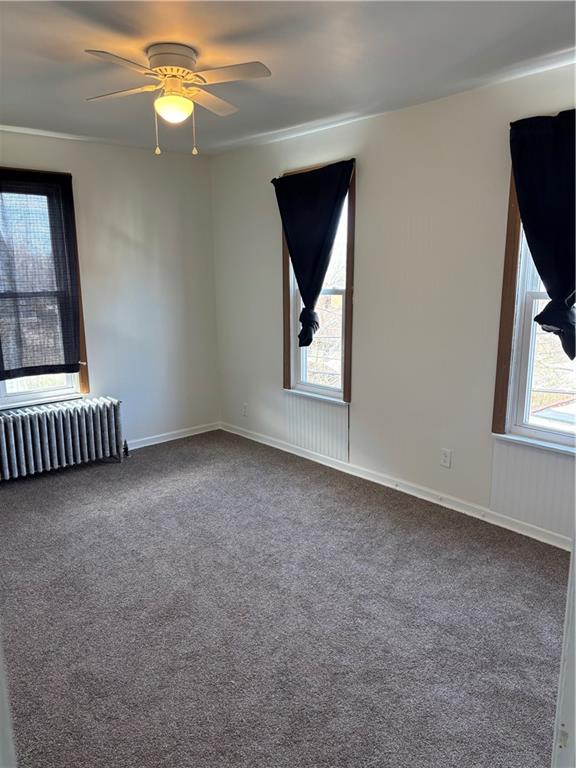 16 Oak Street Manor, PA 15665 - Photo 4 of 18 an empty room with windows and fan