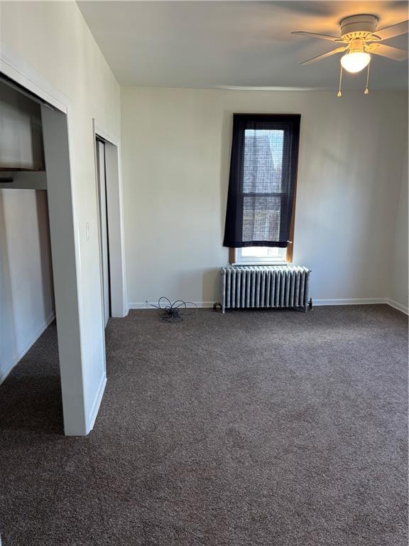 16 Oak Street Manor, PA 15665 - Photo 8 of 18 a view of an empty room with a fireplace and a window