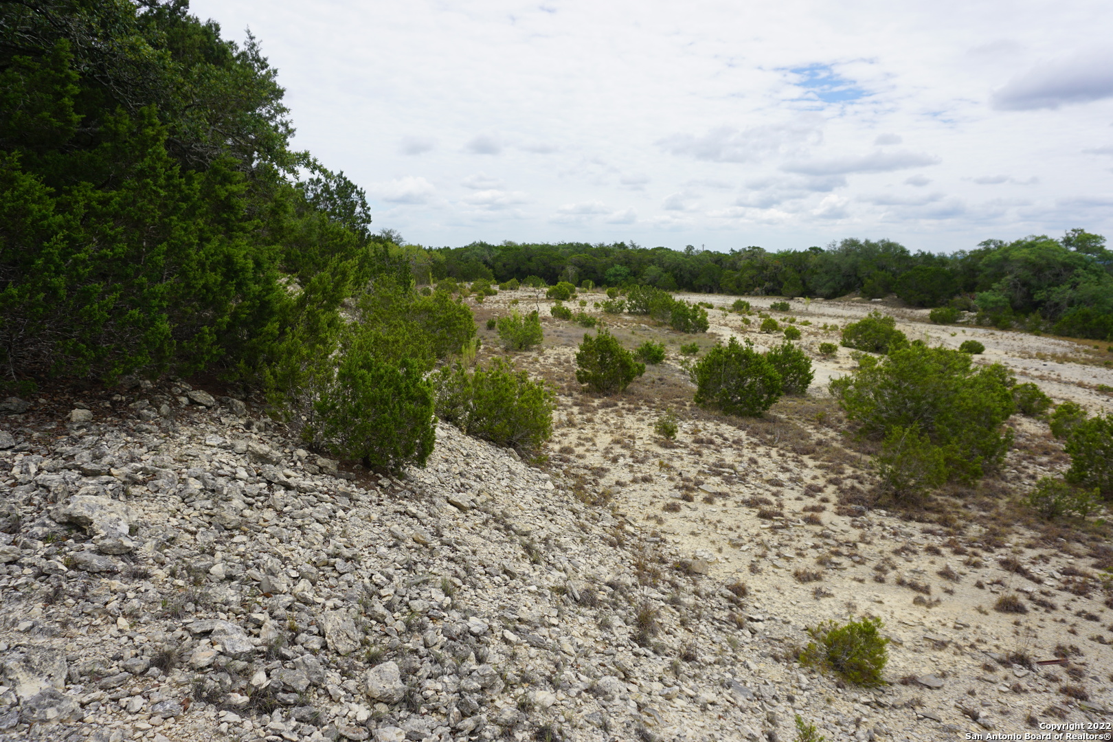 127 Leaders Hill Road Wimberley, TX 78676 - Photo 24 of 43 a view of a lake with houses in the back