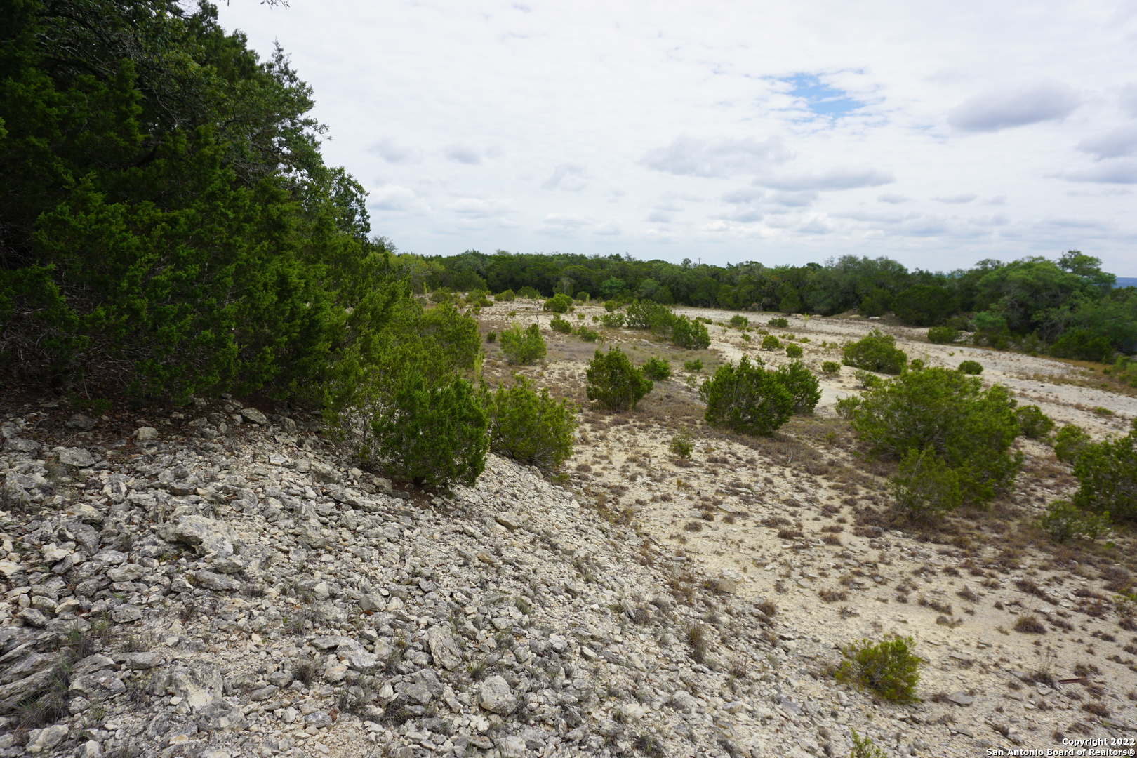 127 Leaders Hill Road Wimberley, TX 78676 - Photo 26 of 43 a view of a lake with houses in back