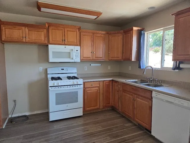 a kitchen with stainless steel appliances granite countertop a sink stove and cabinets