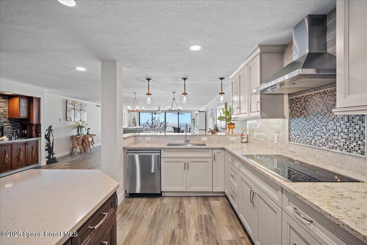 3221 South Atlantic Avenue, Unit 703 Cocoa Beach, FL 32931 - Photo 11 of 77 a kitchen with a sink stove and cabinets