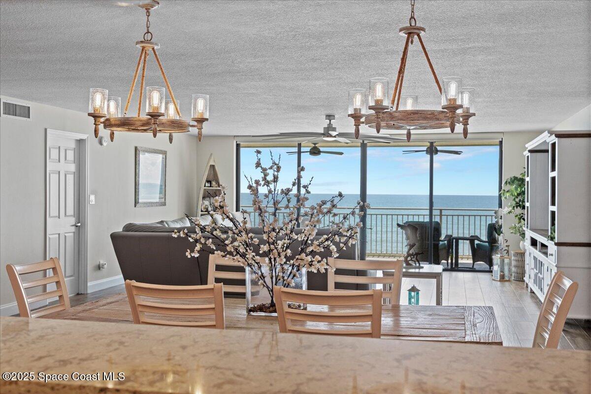 3221 South Atlantic Avenue, Unit 703 Cocoa Beach, FL 32931 - Photo 14 of 77 a view of living room filled with furniture and chandelier
