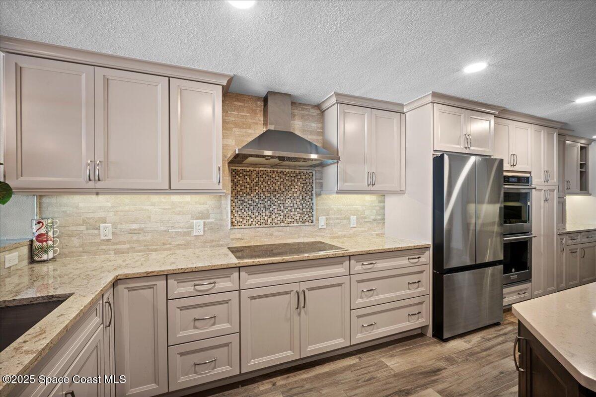 3221 South Atlantic Avenue, Unit 703 Cocoa Beach, FL 32931 - Photo 15 of 77 a kitchen with stainless steel appliances granite countertop a refrigerator sink and cabinets