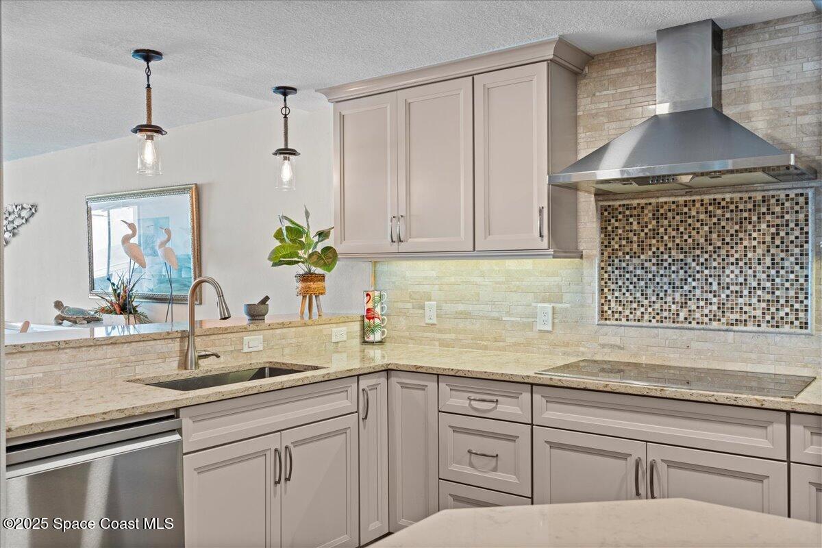 3221 South Atlantic Avenue, Unit 703 Cocoa Beach, FL 32931 - Photo 16 of 77 a kitchen with a sink and cabinets