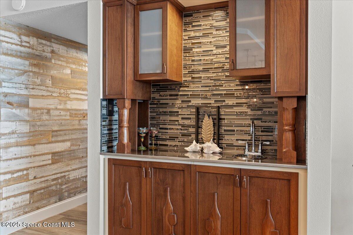 3221 South Atlantic Avenue, Unit 703 Cocoa Beach, FL 32931 - Photo 20 of 77 a bathroom with a granite countertop sink and a mirror