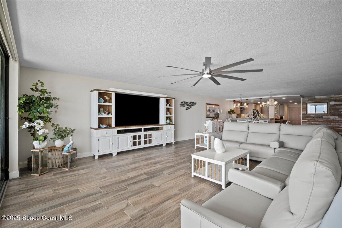 3221 South Atlantic Avenue, Unit 703 Cocoa Beach, FL 32931 - Photo 24 of 77 a living room with furniture and a flat screen tv