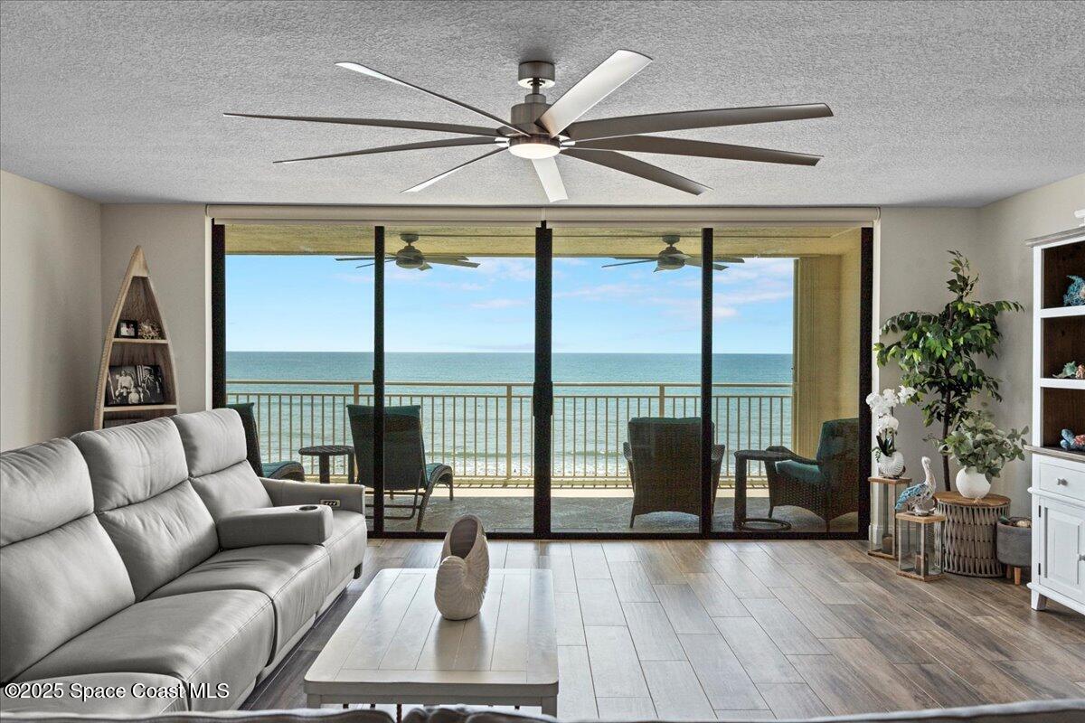 3221 South Atlantic Avenue, Unit 703 Cocoa Beach, FL 32931 - Photo 25 of 77 a living room with furniture and a large window with outer view