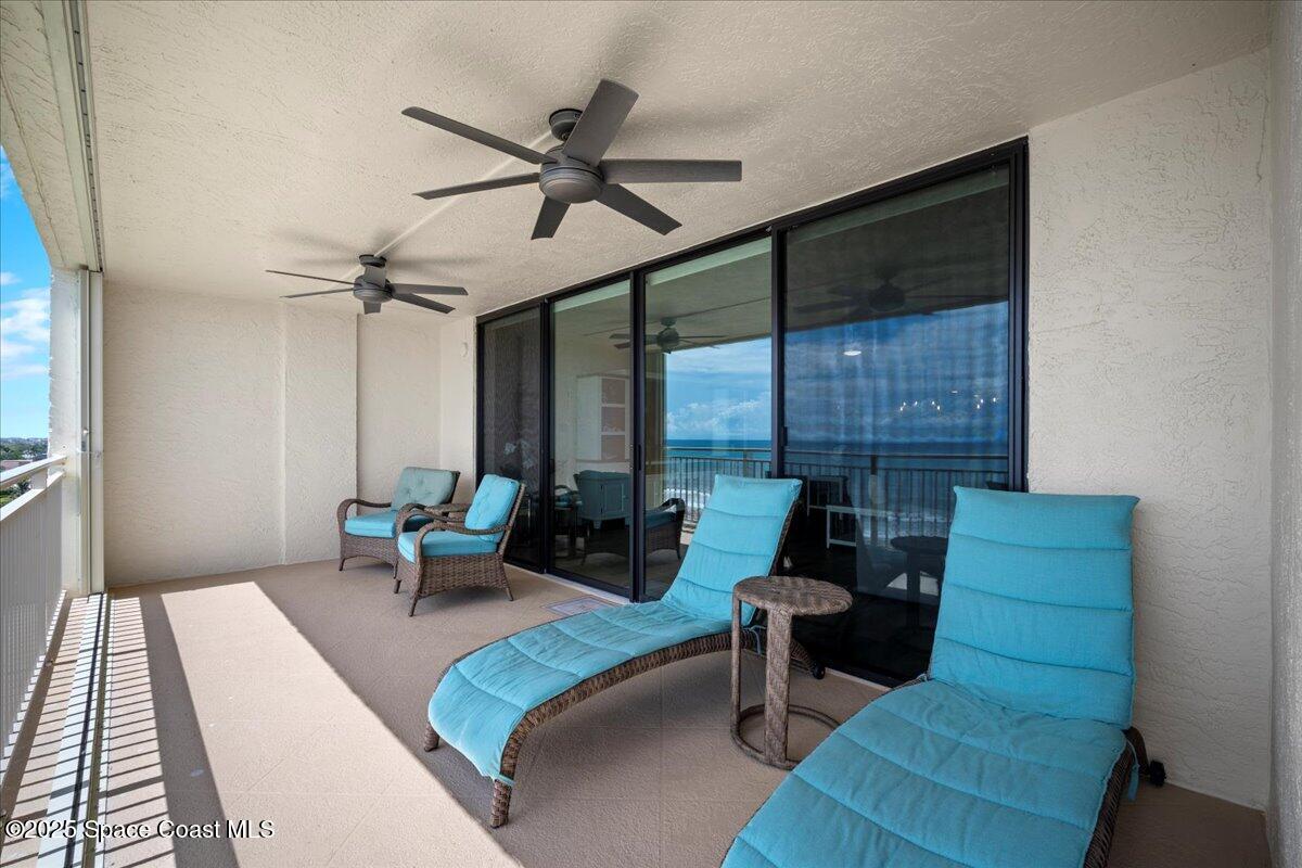 3221 South Atlantic Avenue, Unit 703 Cocoa Beach, FL 32931 - Photo 28 of 77 a living room with furniture and a large window