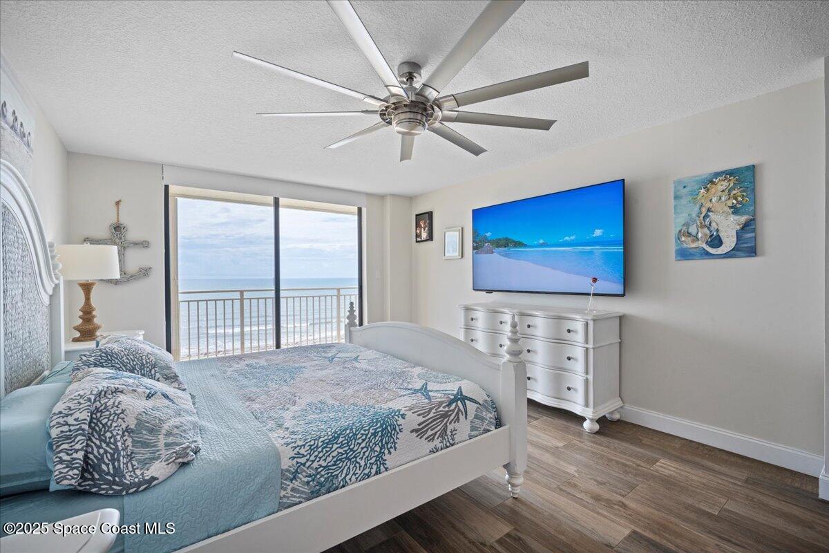 3221 South Atlantic Avenue, Unit 703 Cocoa Beach, FL 32931 - Photo 33 of 77 a bedroom with a bed and a flat screen tv