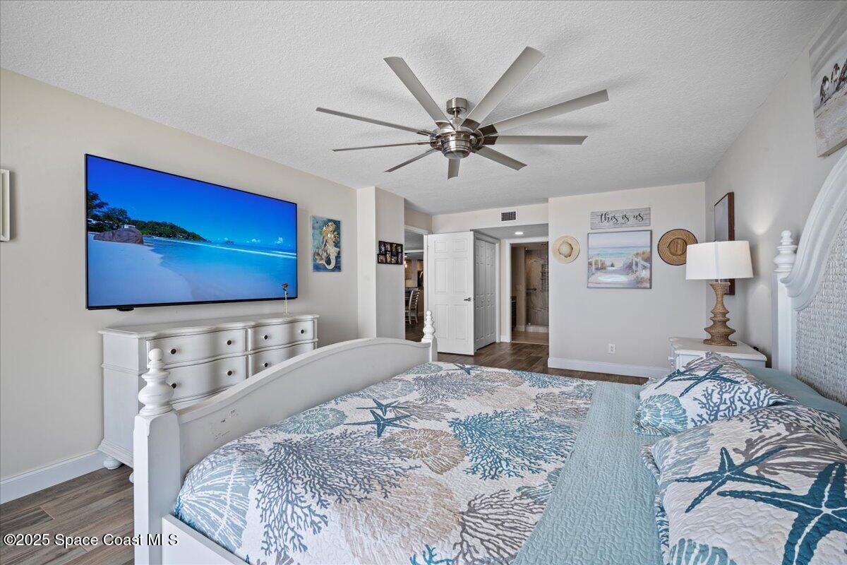 3221 South Atlantic Avenue, Unit 703 Cocoa Beach, FL 32931 - Photo 34 of 77 a bedroom with a bed and a flat screen tv