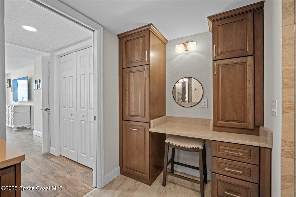 3221 South Atlantic Avenue, Unit 703 Cocoa Beach, FL 32931 - Photo 35 of 77 a view of a hallway that has mirror on the wall
