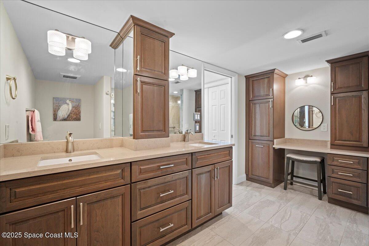 3221 South Atlantic Avenue, Unit 703 Cocoa Beach, FL 32931 - Photo 36 of 77 a spacious bathroom with a sink a mirror and a bathtub