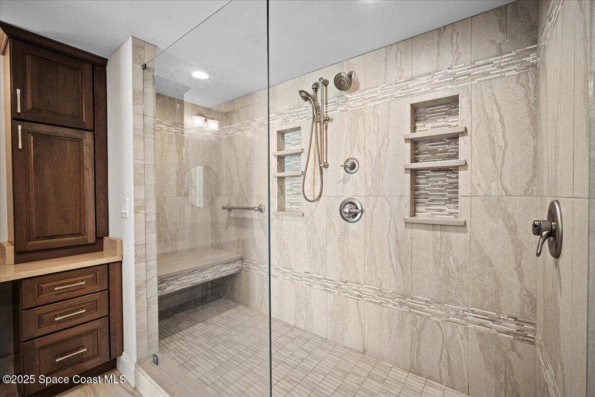 3221 South Atlantic Avenue, Unit 703 Cocoa Beach, FL 32931 - Photo 38 of 77 a bathroom with a shower and a sink